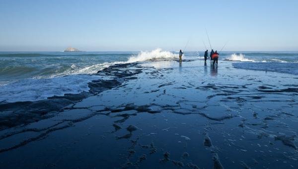 Fishermen take their chances on Flat Rock, photograph by John Doogan